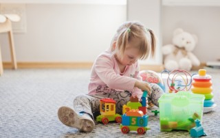 cute-girl-sitting-carpet-playing_23-2147663655
