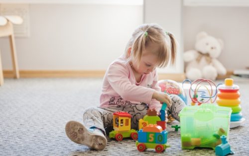cute-girl-sitting-carpet-playing_23-2147663655