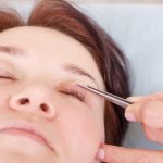 surgeon-applies-bandage-female-patient-s-eyelids-after_124865-370